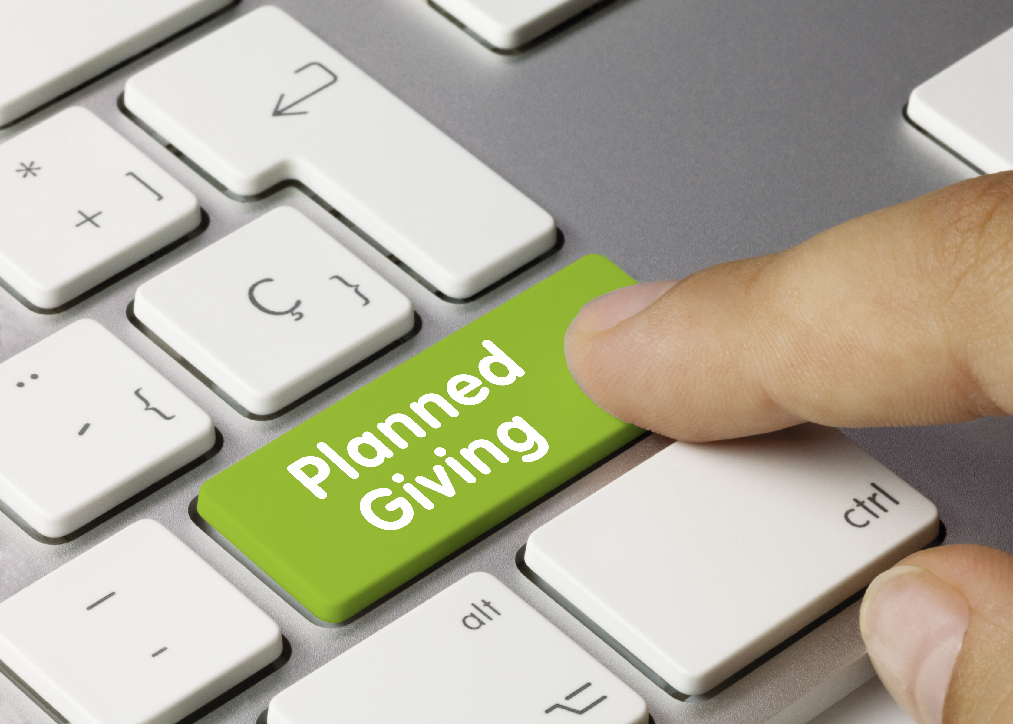 finger pushing a "Planned Giving" button